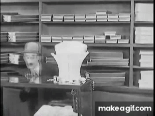 Store detective James Finlayson hides from suspected shoplifter Stan Laurel